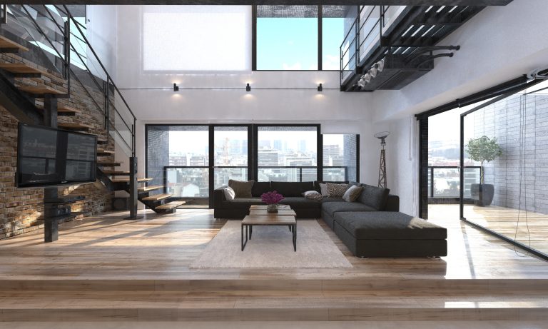 Spacious modern living room with floor-to-ceiling windows, a loft-style staircase, and elegant furnishings, showcasing home remodeling services by Feldman Construction, a general construction company in the Bay Area.