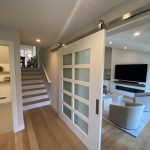 Open-concept entry with sliding barn doors and oak flooring